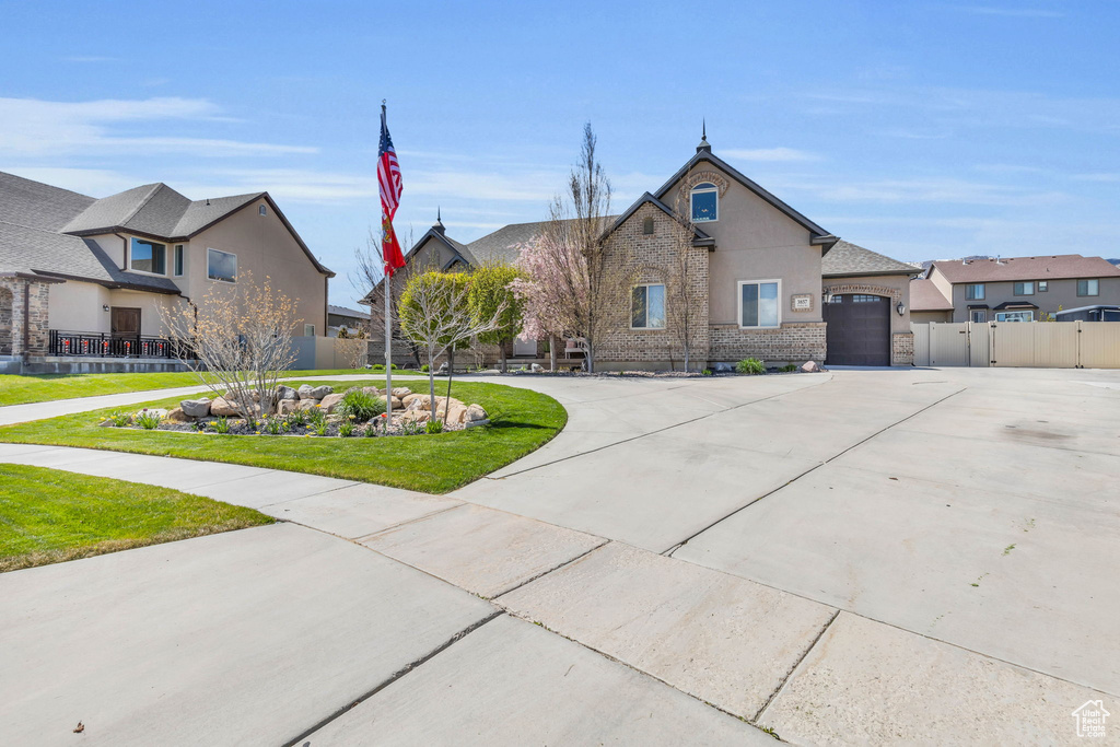 View of front of house with a front lawn and a garage