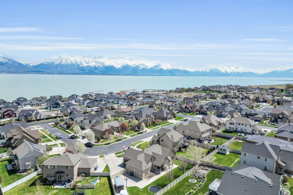 Birds eye view of property featuring a water and mountain view