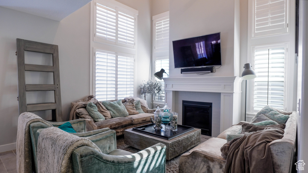 Living room featuring a high ceiling and tile patterned floors