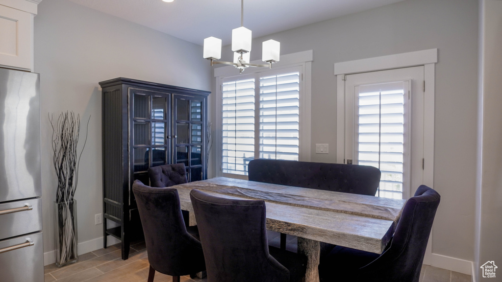 Dining room featuring an inviting chandelier, light hardwood / wood-style flooring, and plenty of natural light