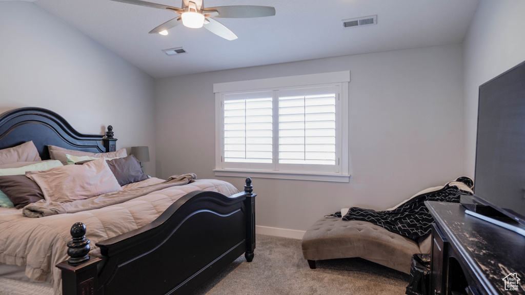 Bedroom with vaulted ceiling, ceiling fan, and light colored carpet