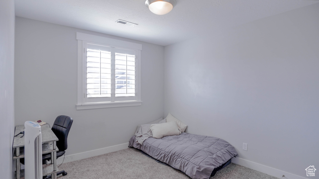 Bedroom featuring light colored carpet