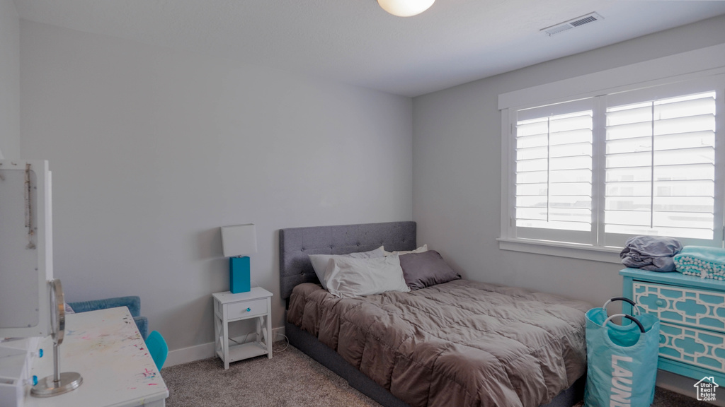 Bedroom featuring light colored carpet