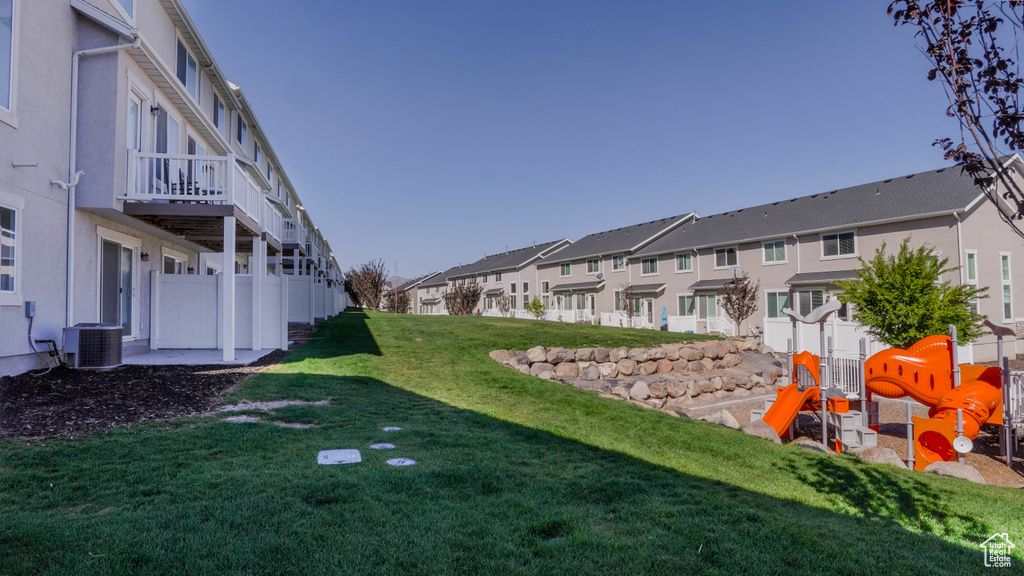 View of yard with cooling unit and a playground