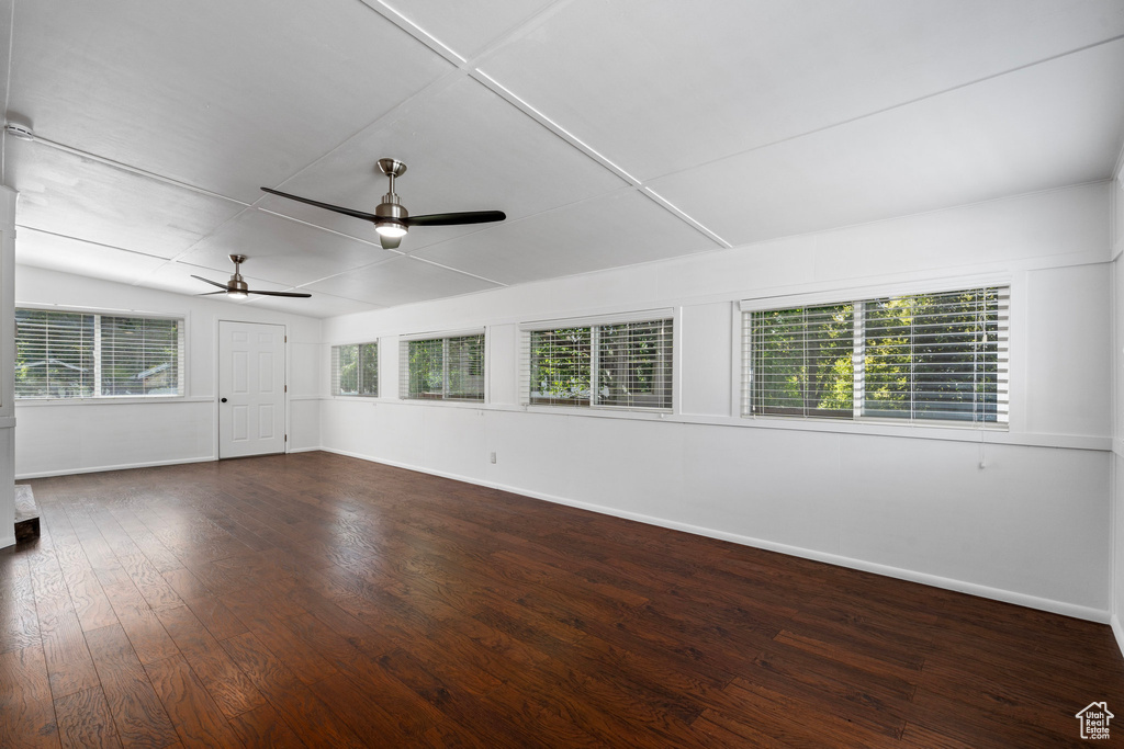 Unfurnished room featuring ceiling fan, hardwood / wood-style flooring, and a wealth of natural light