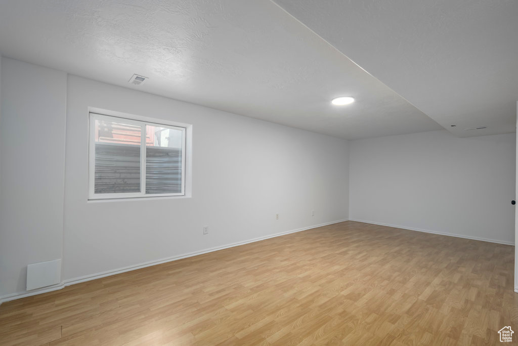 Spare room featuring light hardwood / wood-style floors and a textured ceiling