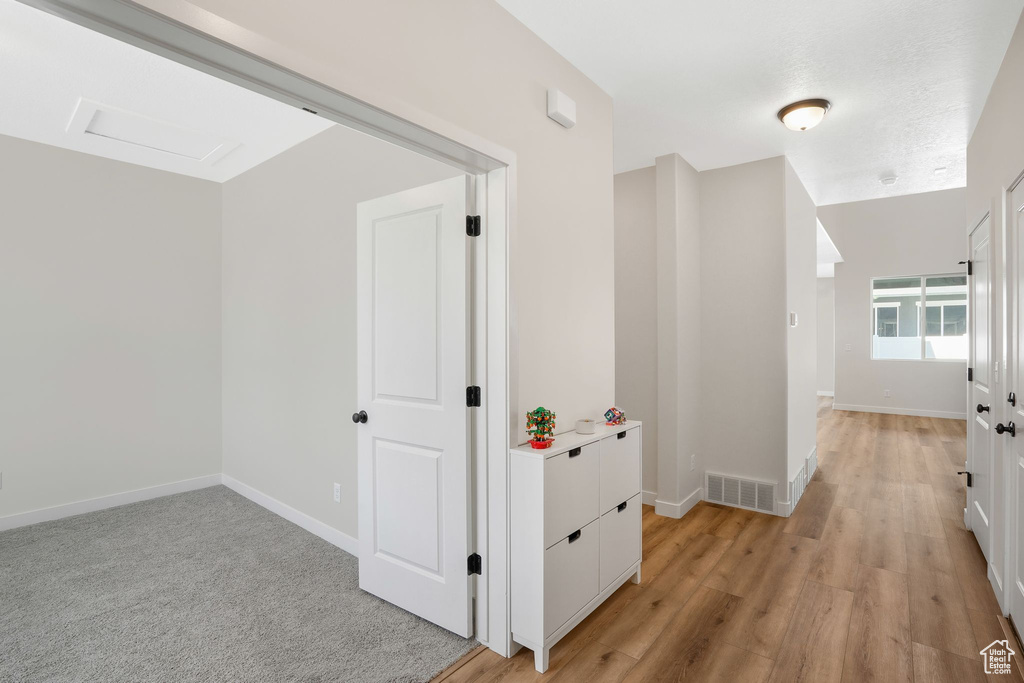 Hallway featuring light wood-type flooring