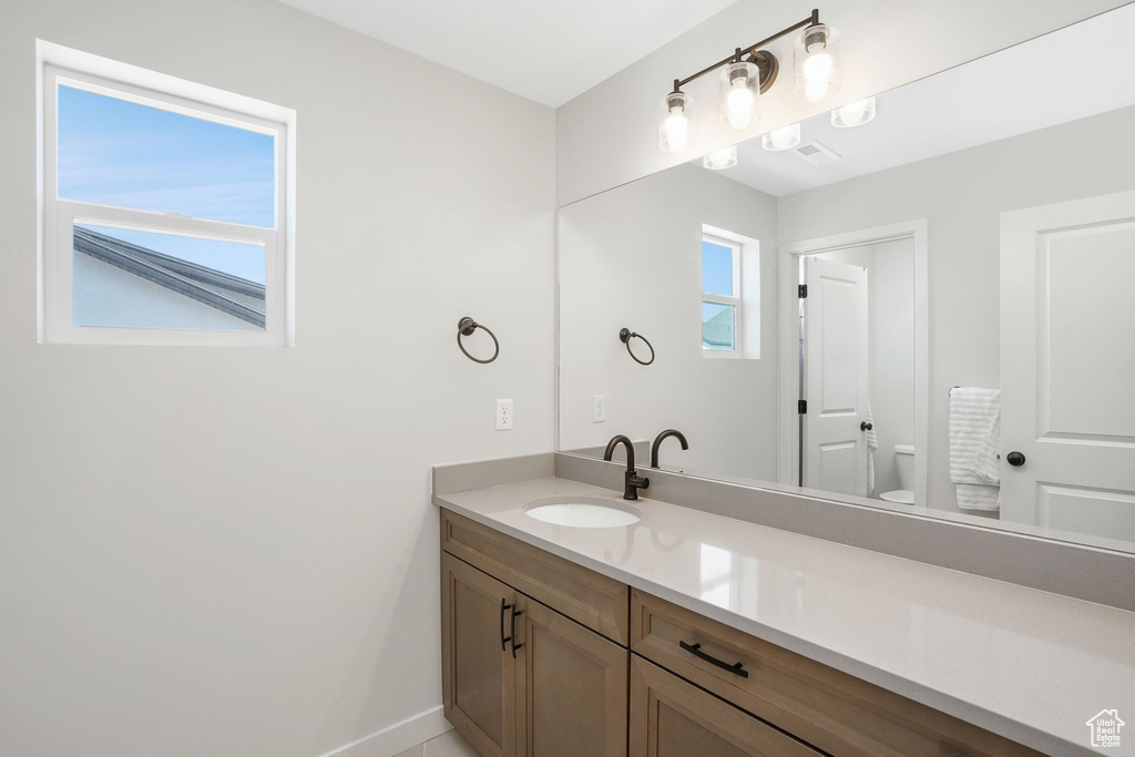 Bathroom featuring vanity and toilet