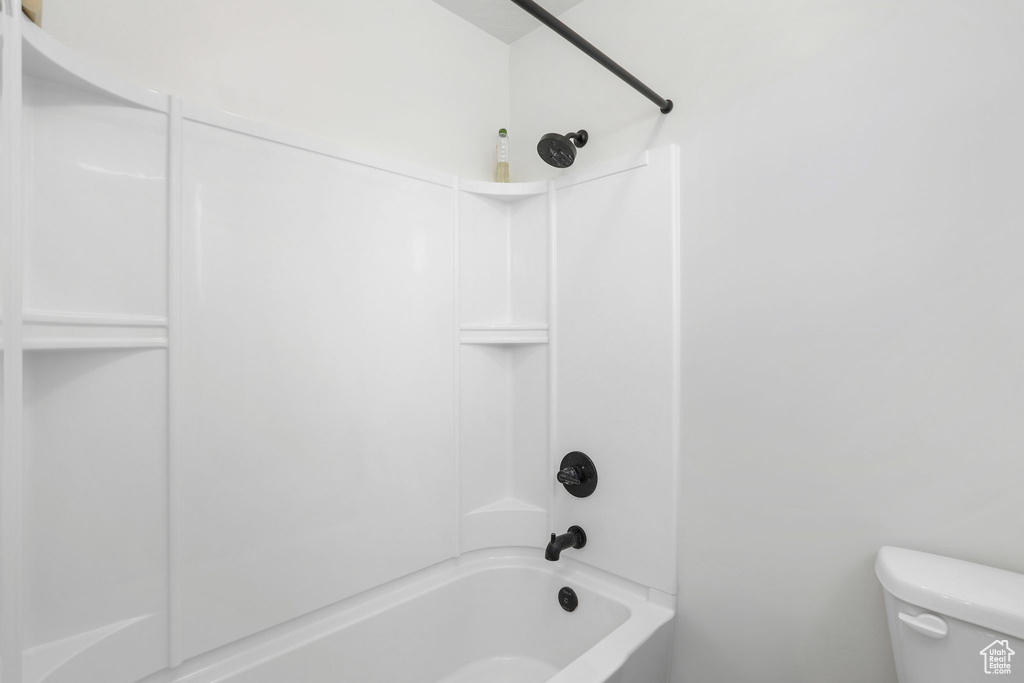 Bathroom with bathing tub / shower combination and toilet