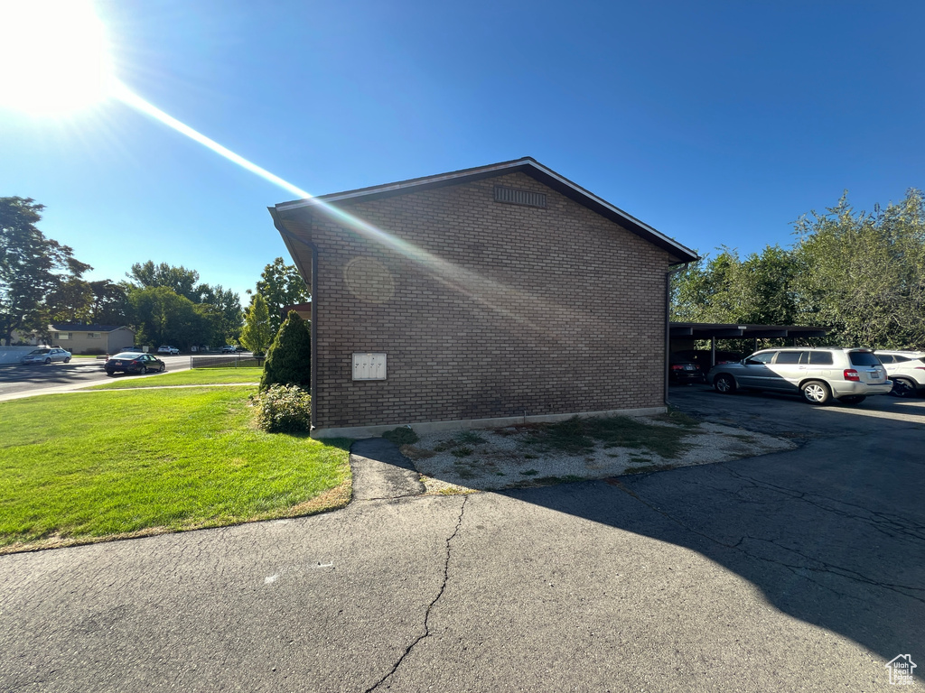 View of home\'s exterior featuring a yard and a carport