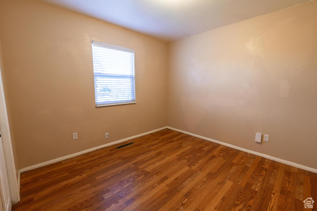 Spare room with dark hardwood / wood-style flooring