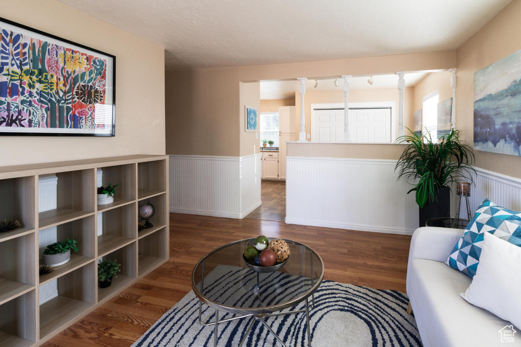 Living room with dark wood-type flooring and a wealth of natural light