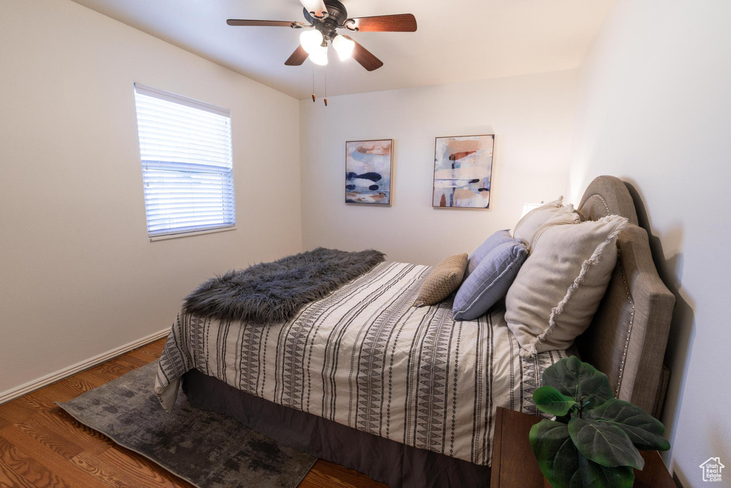 Bedroom with ceiling fan and hardwood / wood-style floors