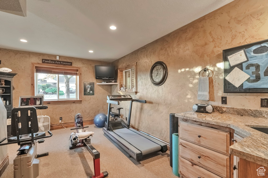 Workout area featuring light carpet