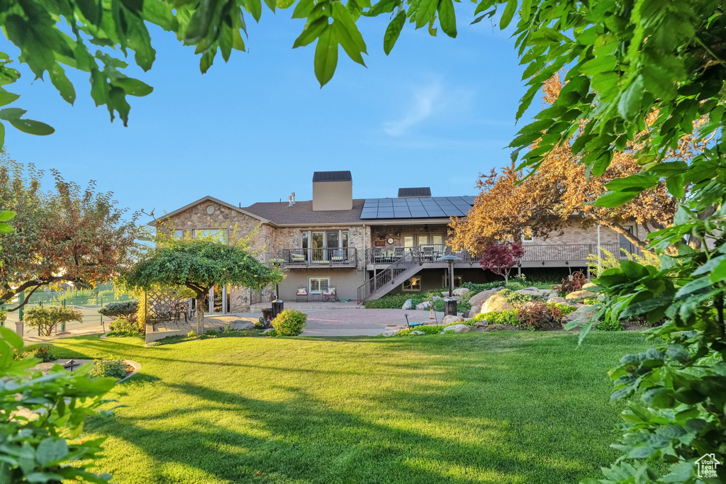 Rear view of property featuring a lawn