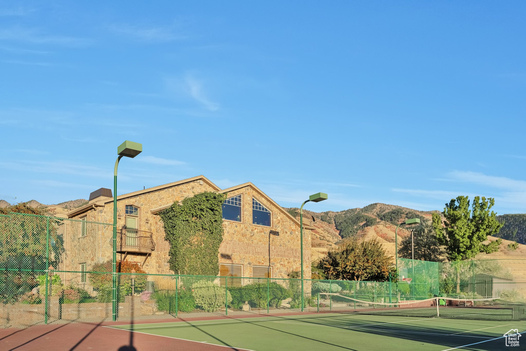 View of tennis court with a mountain view