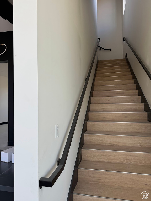 Staircase featuring wood-type flooring