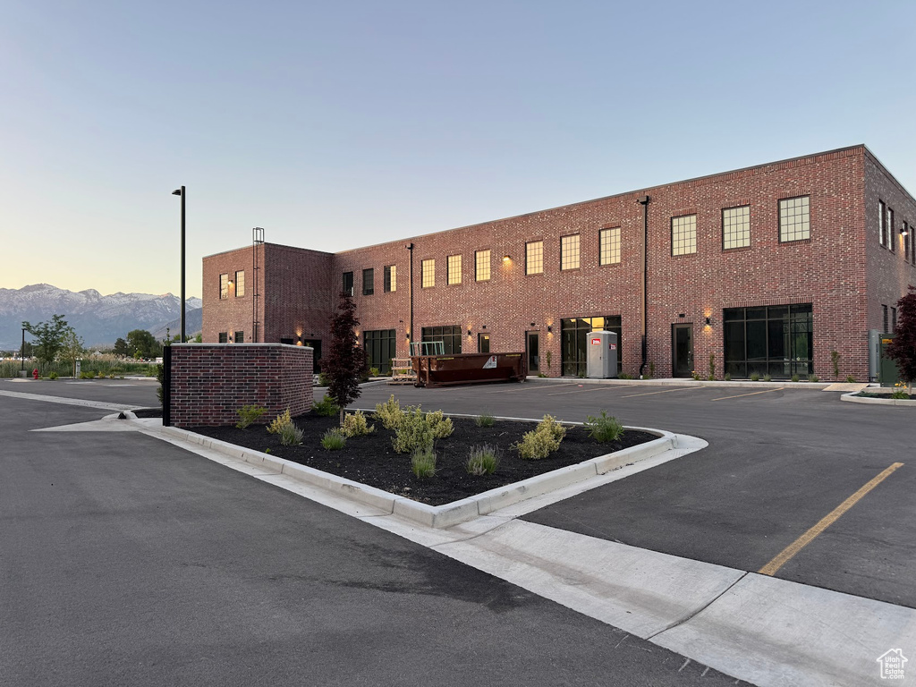 View of property featuring uncovered parking and a mountain view