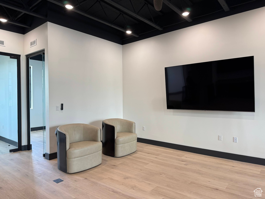 Living area featuring light wood-style flooring and baseboards