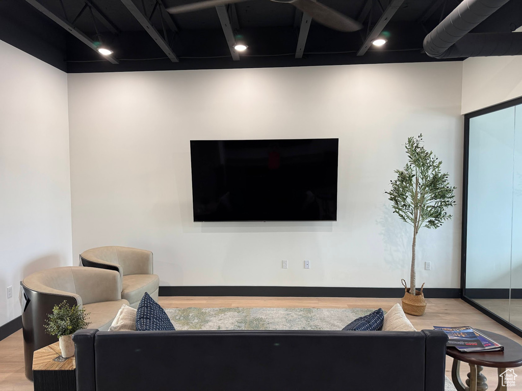 Living area with light wood-style floors and baseboards