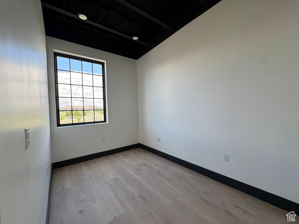 Spare room with light wood-style flooring and baseboards