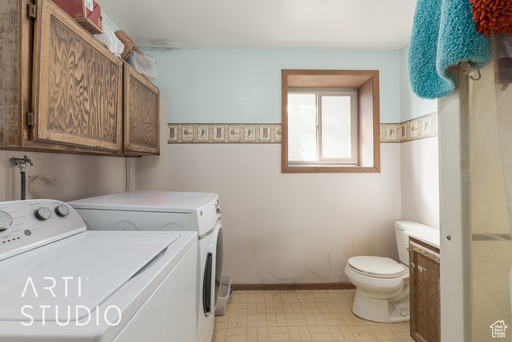 Laundry room with washer and clothes dryer