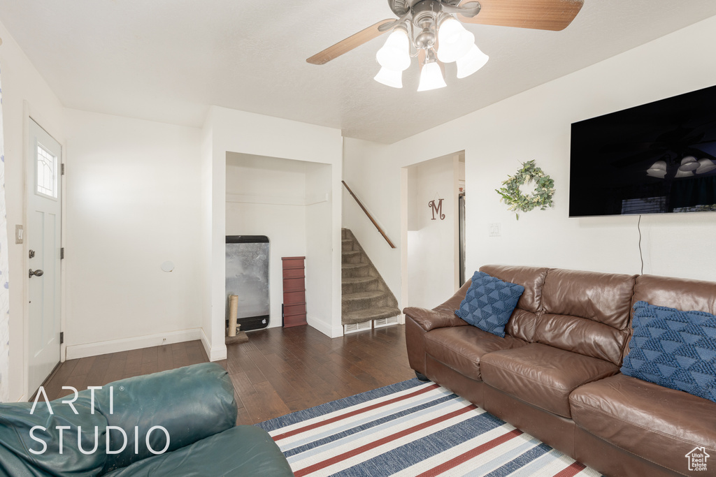 Living room featuring dark hardwood / wood-style flooring and ceiling fan