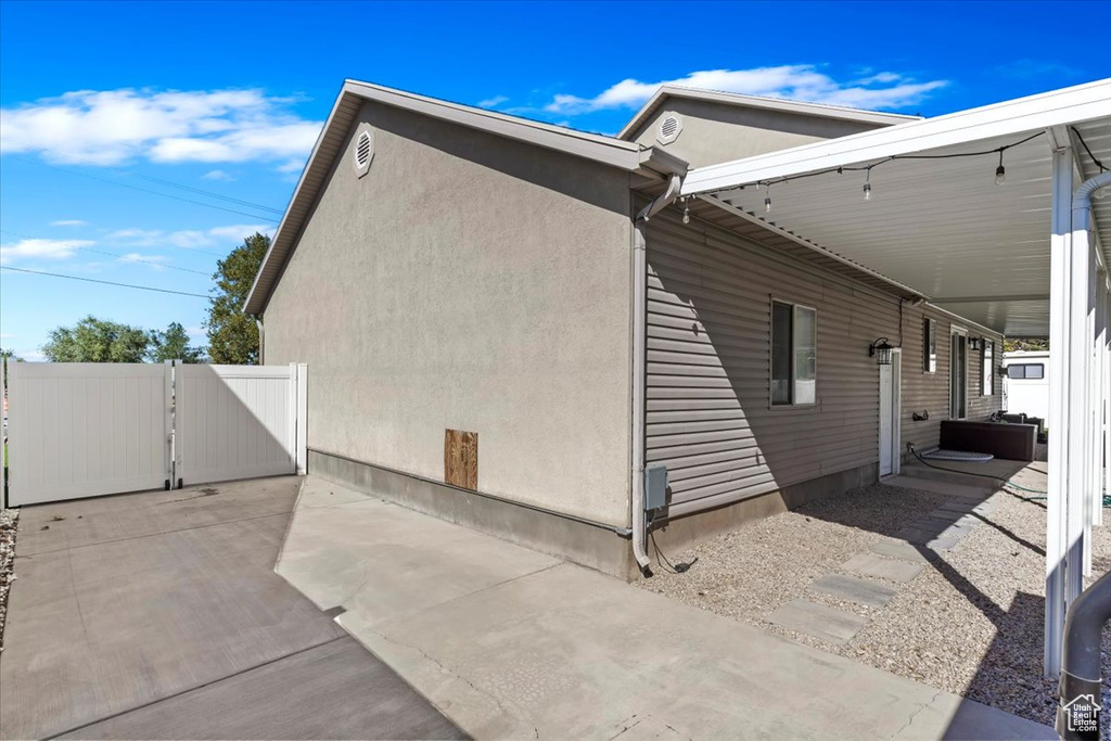 View of side of home with a patio area