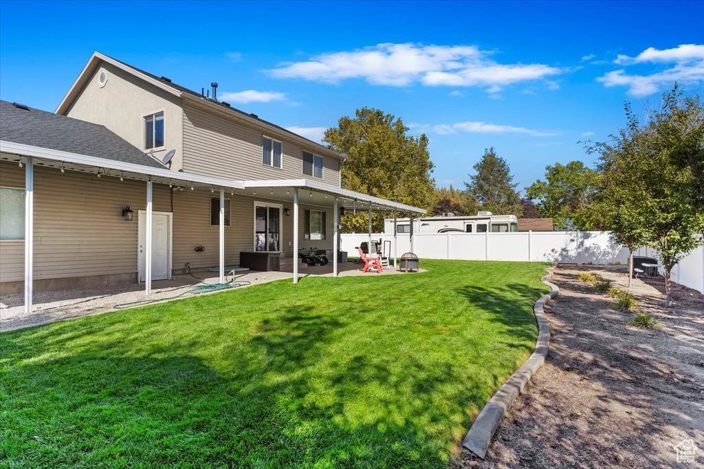 Back of house featuring a patio and a yard