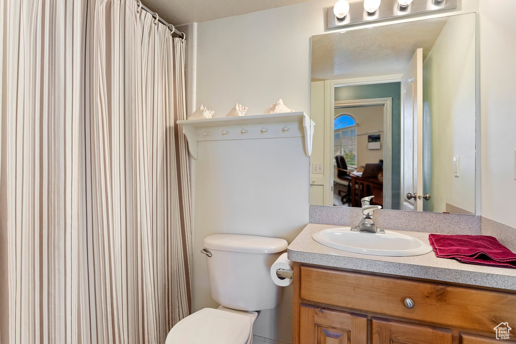 Bathroom with walk in shower, vanity, and toilet