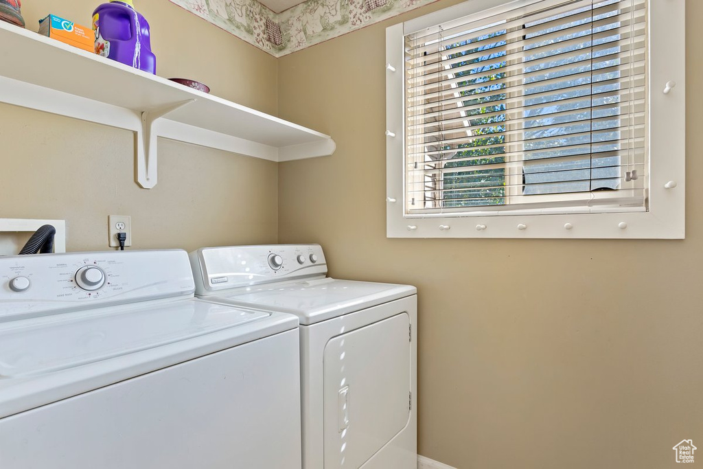 Clothes washing area featuring washer and dryer