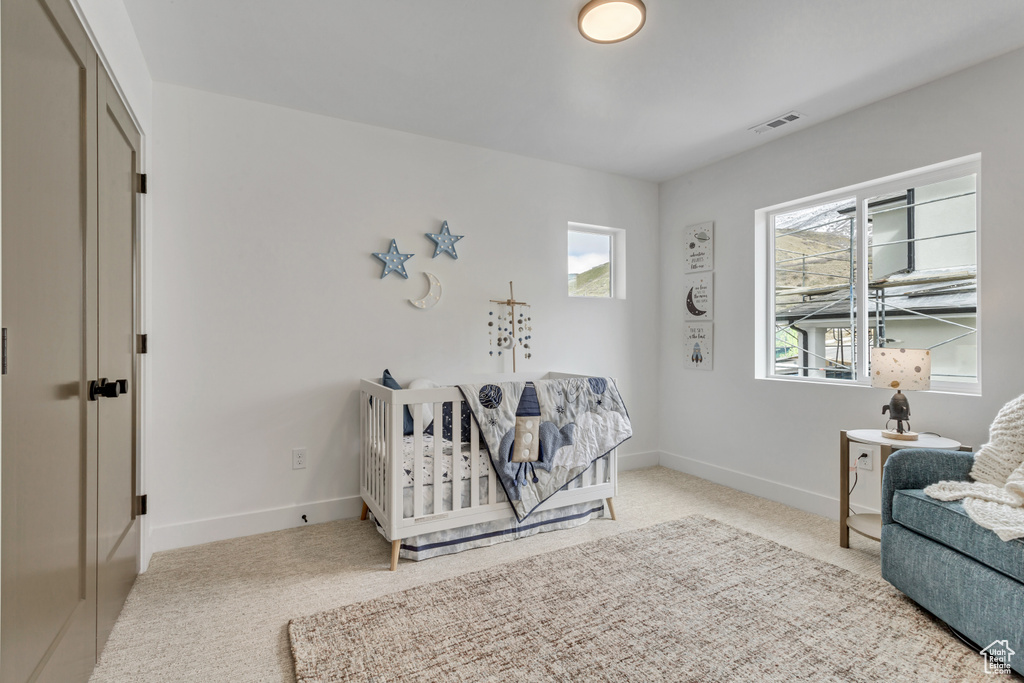 Bedroom with light colored carpet