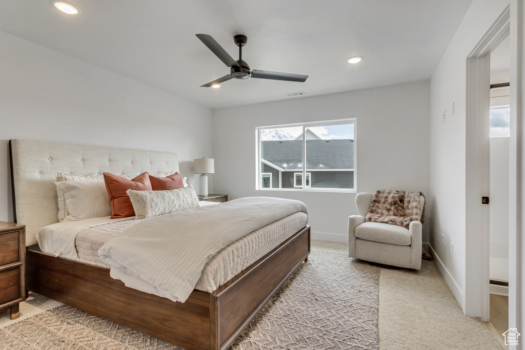 Carpeted bedroom featuring ceiling fan