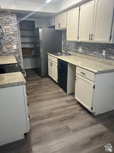 Kitchen with dishwasher, dark hardwood / wood-style flooring, tasteful backsplash, and white cabinetry