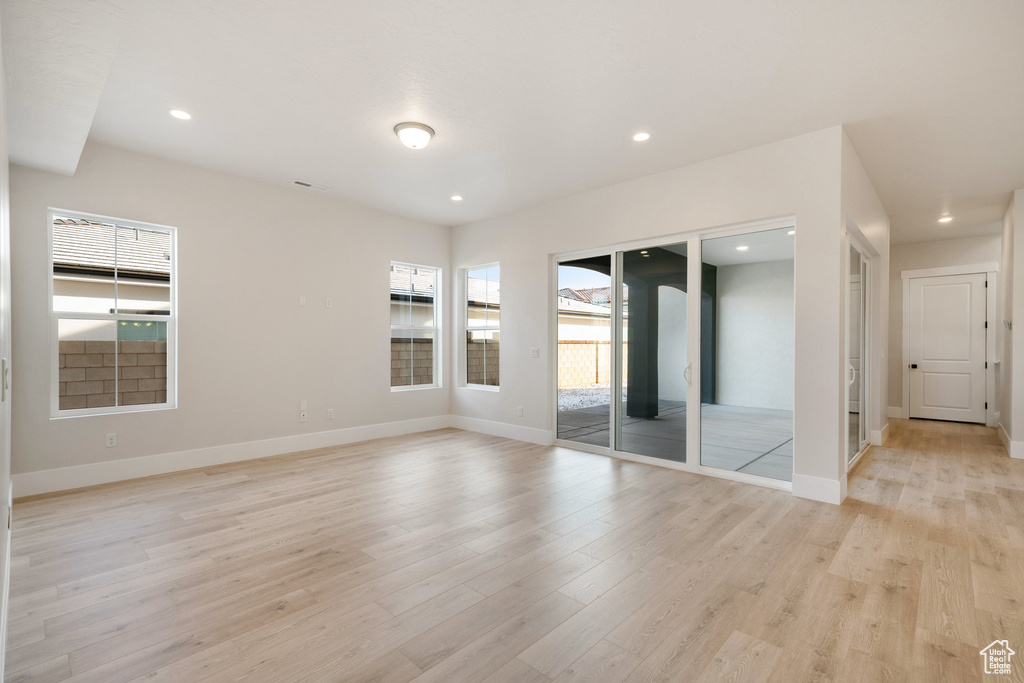 Empty room featuring light hardwood / wood-style flooring and plenty of natural light