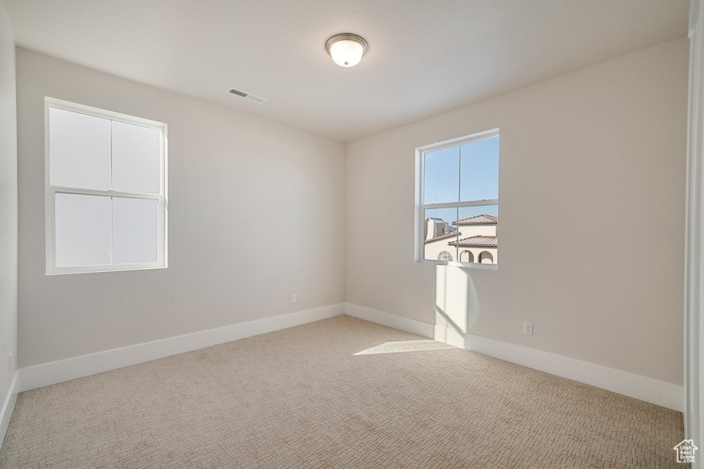 Spare room with light colored carpet