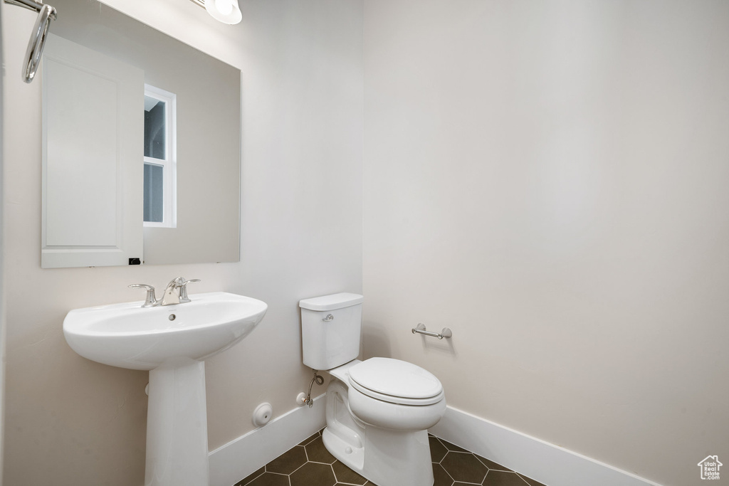 Bathroom featuring sink and toilet