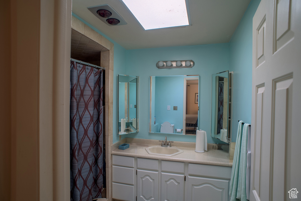 Bathroom featuring vanity and a skylight