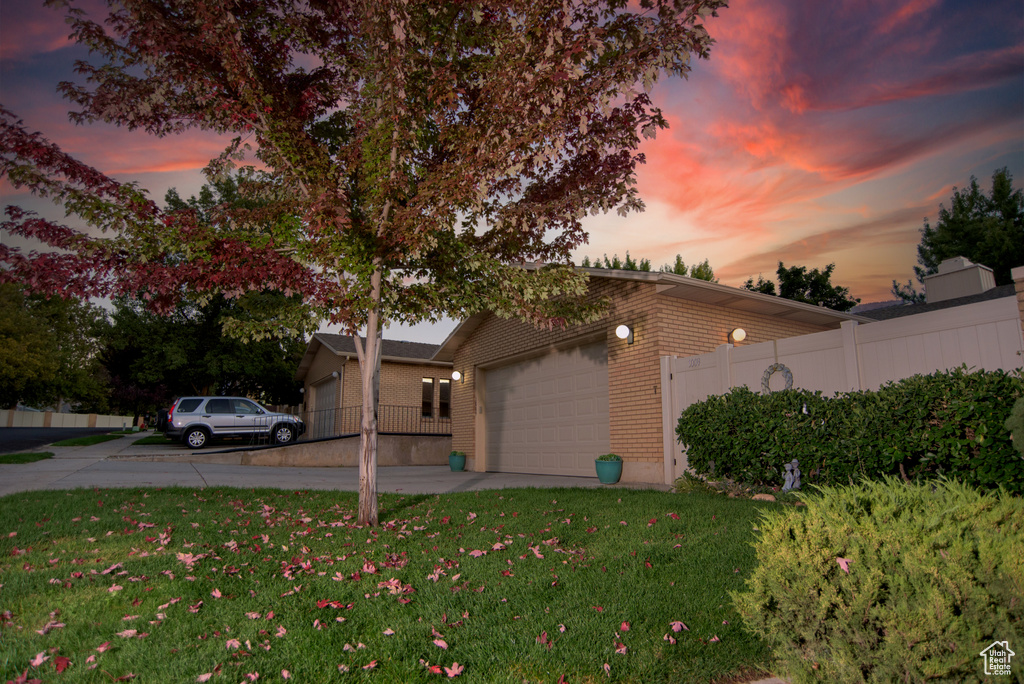 Yard at dusk with a garage