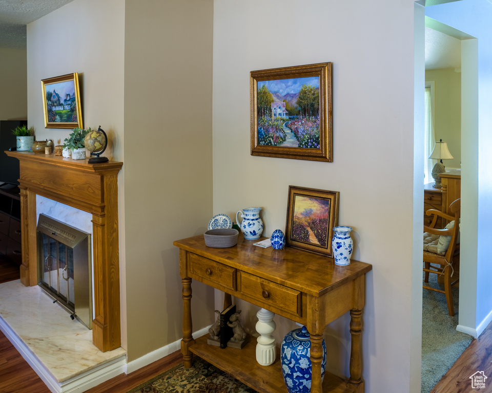 Interior space with a textured ceiling and hardwood / wood-style floors