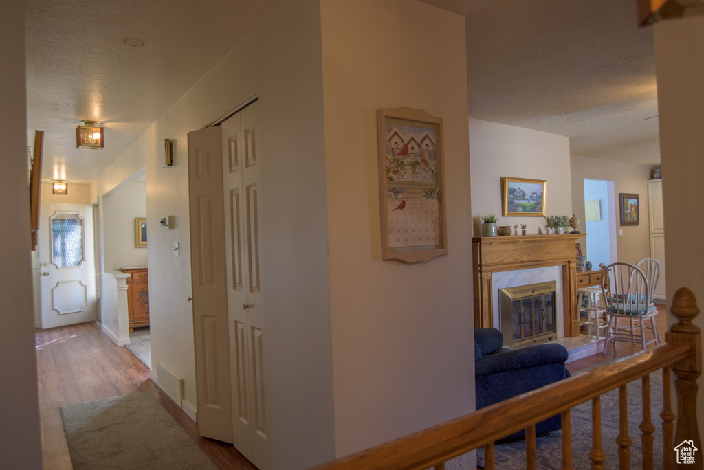 Hallway with light hardwood / wood-style flooring