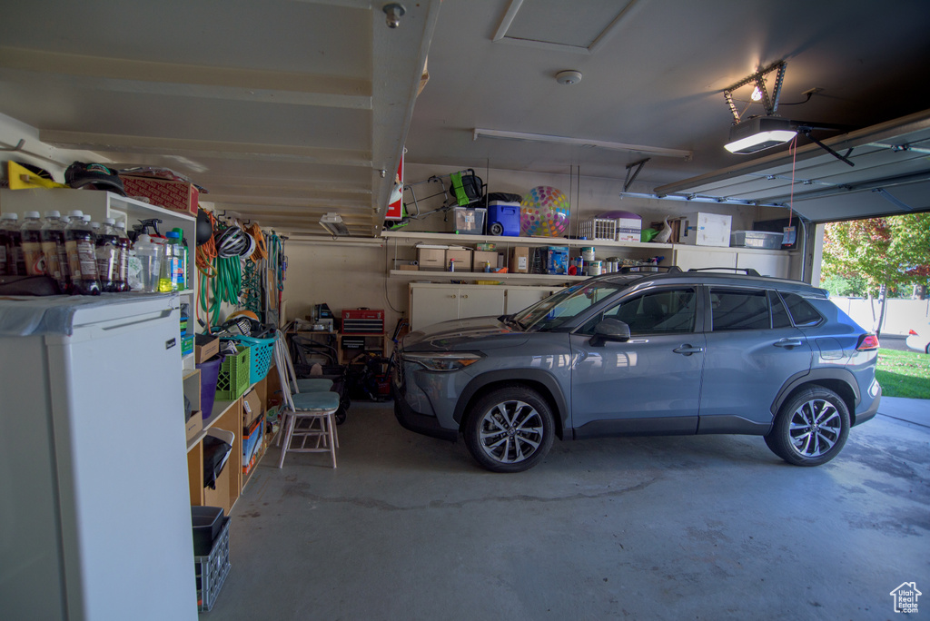 Garage featuring a garage door opener