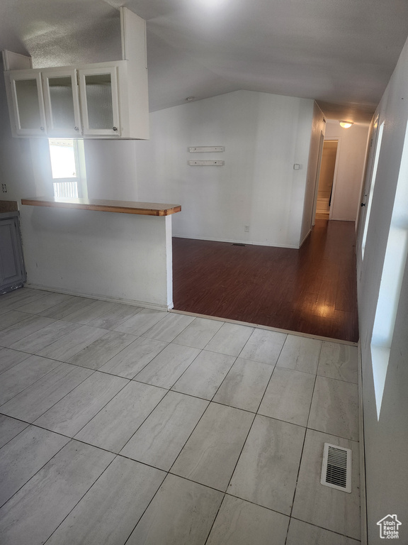 Kitchen featuring wood finished floors and lofted ceiling