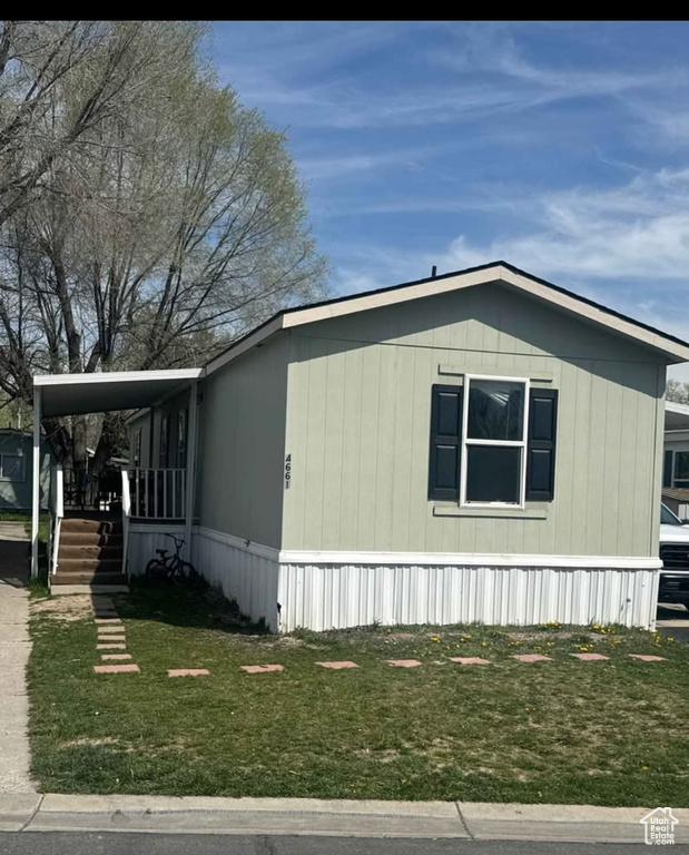 View of side of property with a yard