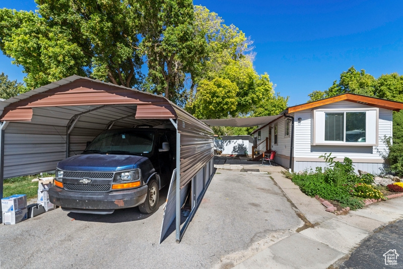 View of vehicle parking featuring a carport