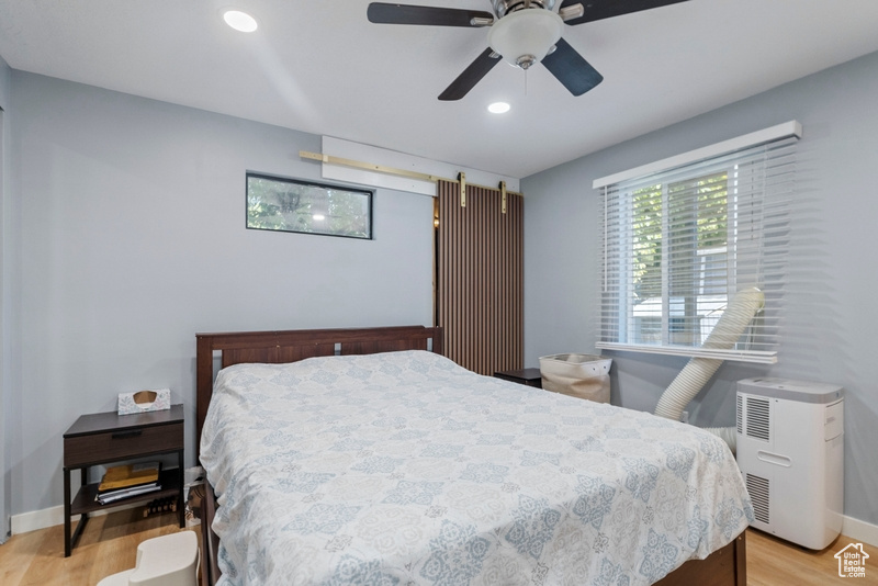 Bedroom with light hardwood / wood-style flooring and ceiling fan