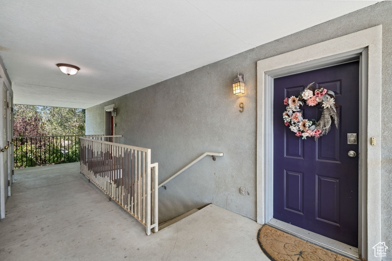 View of exterior entry featuring covered porch