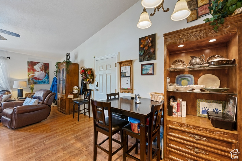 Dining room featuring ceiling fan, lofted ceiling, and hardwood / wood-style floors