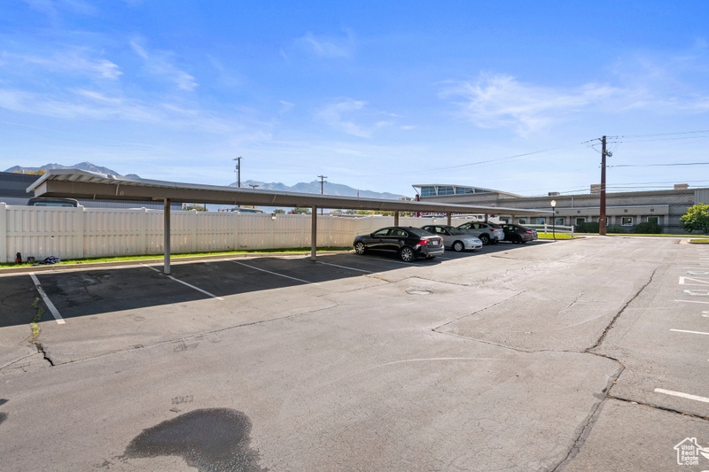 View of vehicle parking featuring a carport