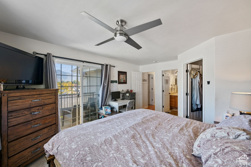 Bedroom featuring ceiling fan, ensuite bathroom, and access to exterior